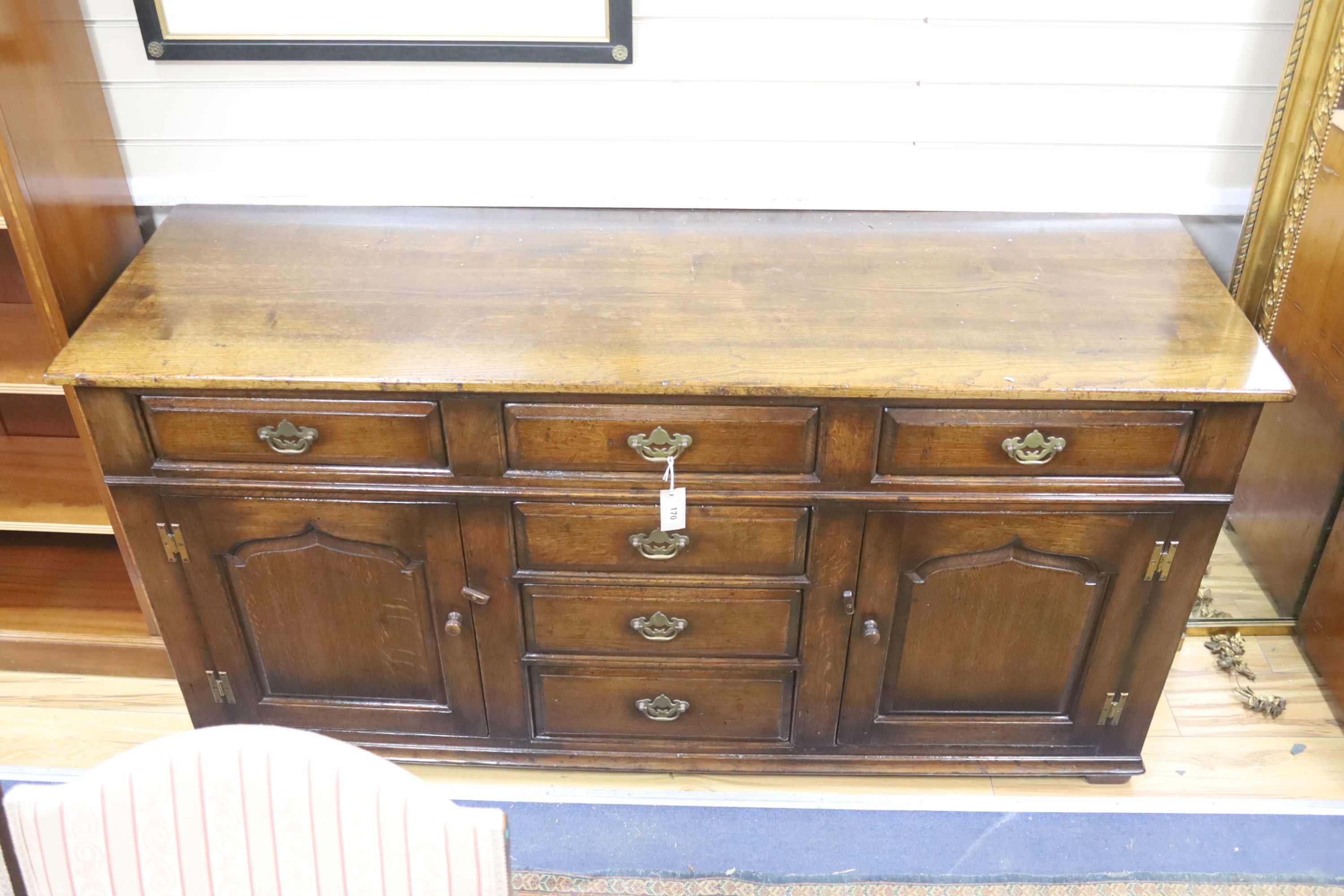 An 18th century style oak low dresser, length 168cm, depth 53cm, height 83cm